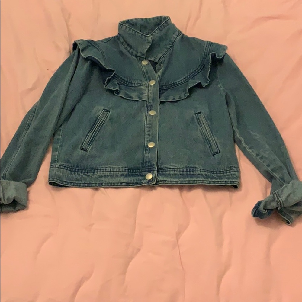 Denim jacket with ruffles on top.